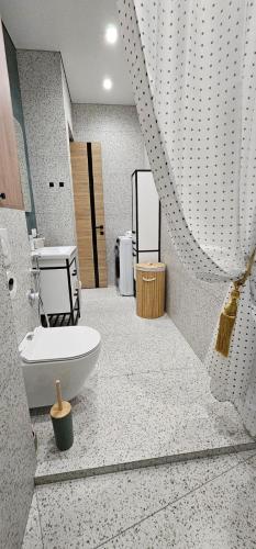 a bathroom with a sink and a toilet in a room at LUX-Апартаменты Manhattan style на Тохтарова in Ustʼ-Kamenogorsk