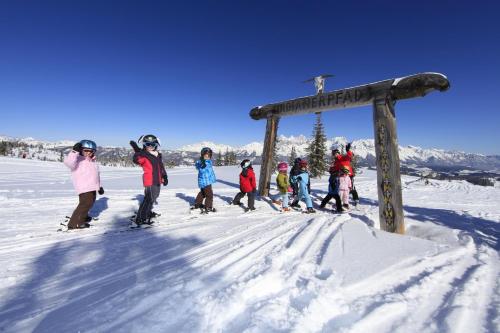 a group of people on skis in the snow at Ferienlodge Edelstein in Forstau