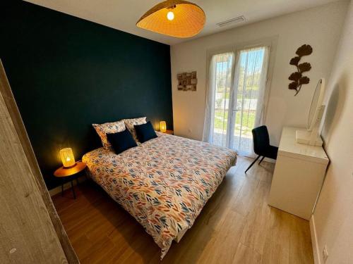 a bedroom with a bed and a green wall at Maison de vacances in Le Teich