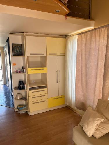 a yellow cabinet in a living room with a couch at Apartman Savina - 100m od mora in Herceg-Novi