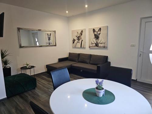 a living room with a couch and a table at Apartments Villa Stivan in Solin