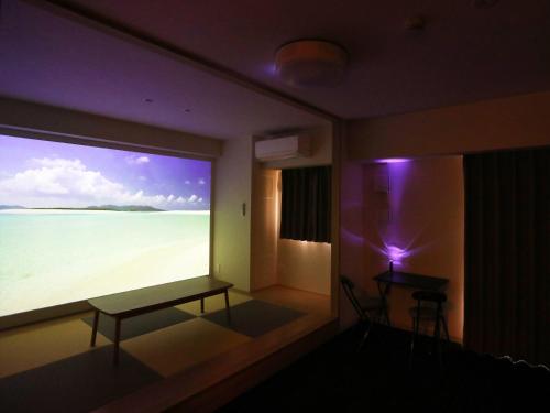 a room with a large window with a view of the beach at MERBABU STAY OSAKA in Osaka