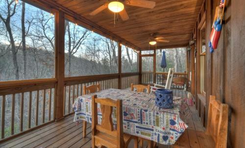 a dining table on the porch of a cabin at American Dream Americana decor close to downtown Blue Ridge in Blue Ridge