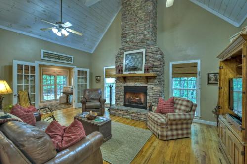 a living room with couches and a stone fireplace at Southern Living Cottage Cozy up by the fire relax on the porch and enjoy peaceful surroundings in Blue Ridge