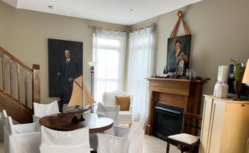 a living room with a table and chairs and a fireplace at Ben Huon Manor, Robertson, Southern Highlands, NSW in Robertson