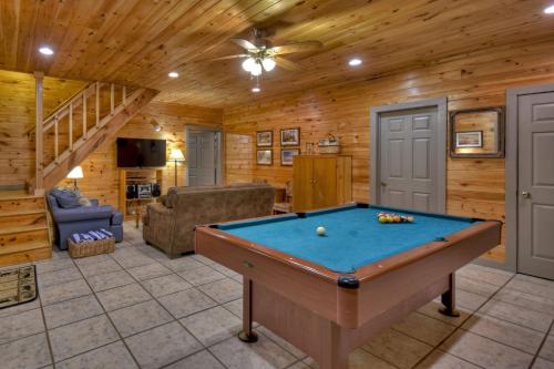 a billiard room with a pool table in a cabin at K6 Lodge Gather around the firepit soak in the hot tub and splash in the creek in Blue Ridge