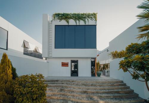 a building with a large window on the side of it at Nas House Private & Shared Villas in Dubai