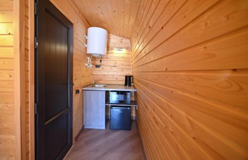 a hallway in a log cabin with a door at Hidden Garden Resort in Garni