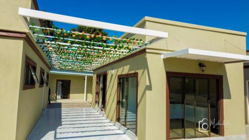 a building with a string of christmas lights on it at Lamamie Suite Lodge in Thohoyandou