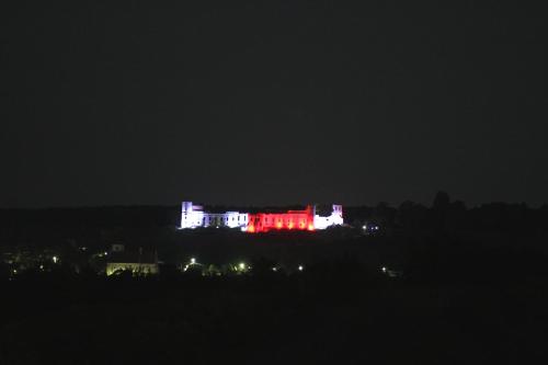 a building lit up in red and white at night at Siedlisko Panorama na Koncu Swiata - Całoroczny domek in Podgórz