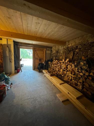 a room with a pile of logs on a wall at Warm and Stylish Boutique Lodge L'Etoile de Savoie in Abondance