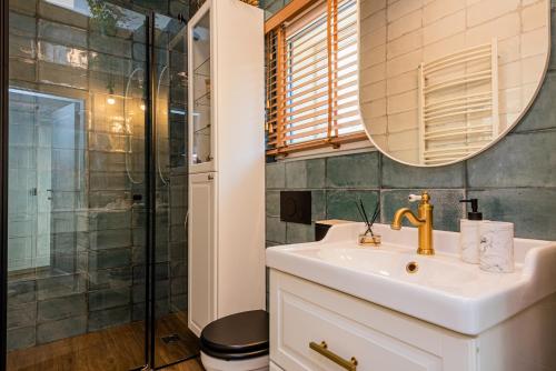 a bathroom with a sink and a shower at Žalia kopa with pool in Palanga