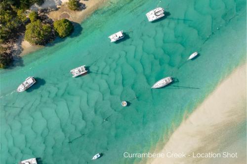 an aerial view of boats in the water on a beach at Pier 8 by Experience Jervis Bay in Huskisson
