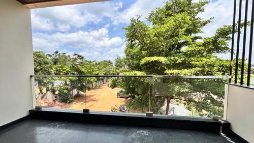 a large balcony with a view of a yard at Arjun Homestay in Hampi