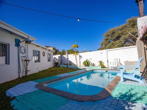 a swimming pool in the yard of a house at Kate's Nest Guesthouse & Backpackers in Windhoek