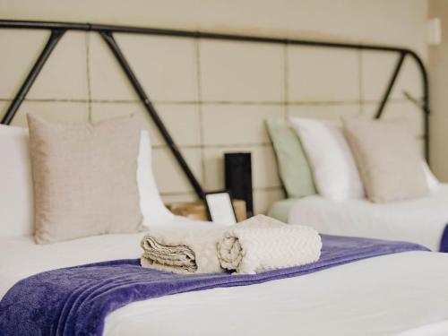 a close up of a bed with a towel on it at Kate's Nest Guesthouse & Backpackers in Windhoek