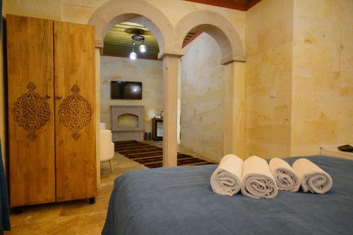 a bedroom with a bed with rolled towels on it at Mayda Cappadocia in Uchisar