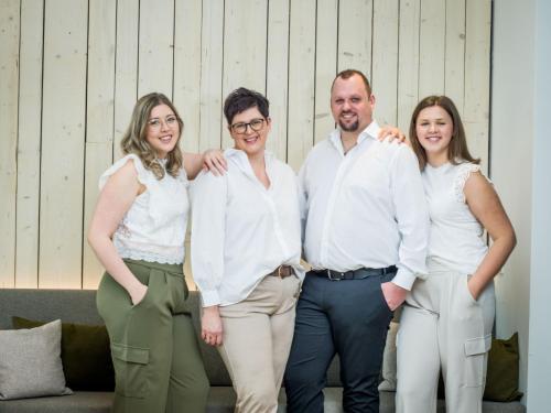 a group of four people posing for a picture at Euler Neuschönau - Naturhotel & Chalets in Neuschönau