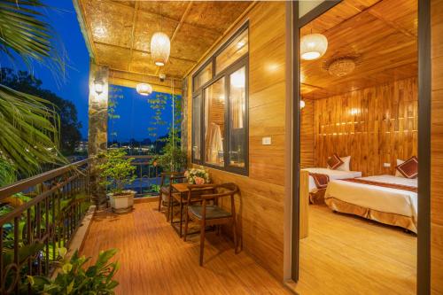 a bedroom with a bed and a desk and a table at Tam Coc Serenity Hotel & Bungalow in Ninh Binh