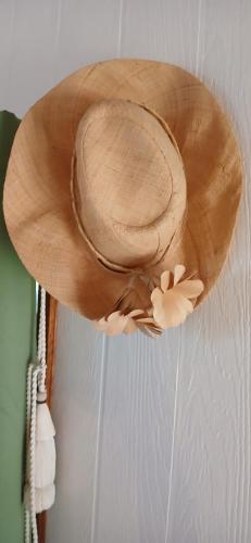 a brown cowboy hat hanging on a wall at Faré tropical atiha in Tuarea