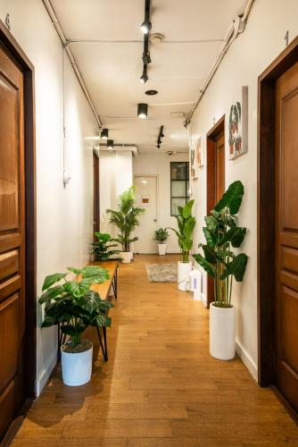 a corridor with potted plants in an office at Homey and Cozey Poblacion Makati S04 in Manila