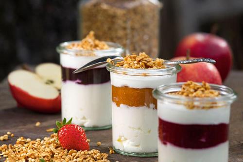 three desserts in jars with strawberries and apples at Hotel Vista Carnica in Kartitsch