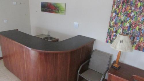 a desk with a lamp and a chair in a room at Bojo Beach Resort in Bortianor