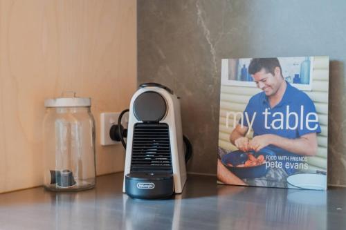 a food scale sitting on a counter next to a box at Ocean Views at Rapanui Lodge- 4BR Gem with Parking in Christchurch