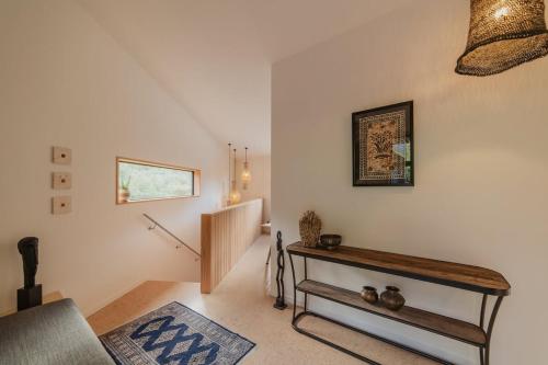 a living room with a table and a stair case at Ocean Views at Rapanui Lodge- 4BR Gem with Parking in Christchurch