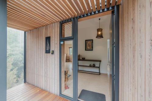 a room with a sliding glass door in a house at Ocean Views at Rapanui Lodge- 4BR Gem with Parking in Christchurch