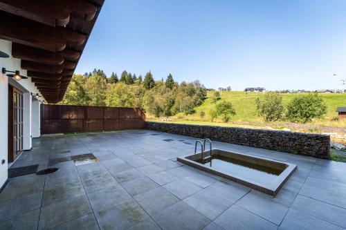 a swimming pool with a sink on a patio at Wellness apartmán Pila na Kvildě in Kvilda