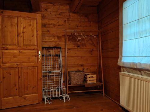 a wooden room with a door and a cage at Chata KORSO v súkromí so záhradou 1200m2 in Terchová