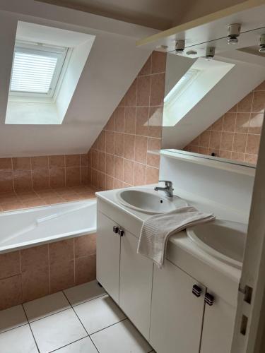 une salle de bain avec un lavabo et une baignoire dans l'établissement La douceur Angevine !, à Les Ponts-de-Cé