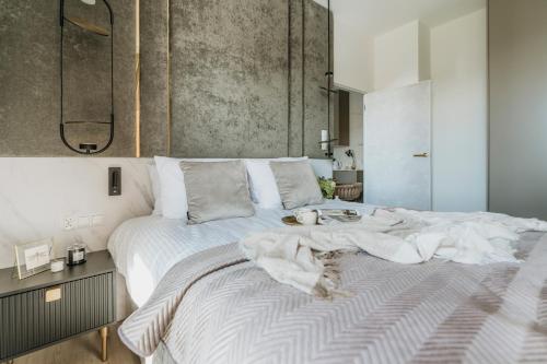 a bedroom with a large bed with white sheets at Sol Marina Resort Wyspa Sobieszewska II - LoftAffair Collection in Wiślinka