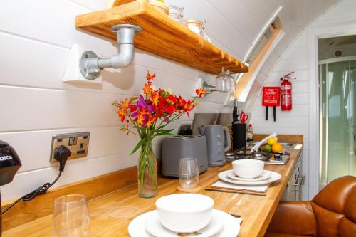 a kitchen with a counter with plates and flowers on it at Prospect House Farm in Scalby