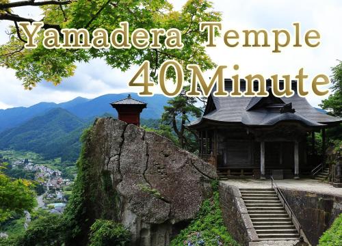 a temple on top of a rock with a mountain at Hotel Koyo in Kaminoyama