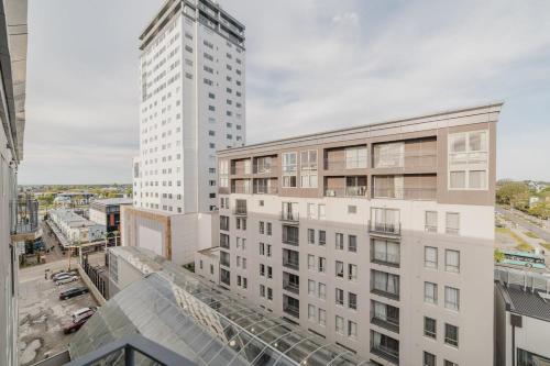 an aerial view of a tall white building at Penthouse Perfection - 2BR Elegance on Worcester St in Christchurch