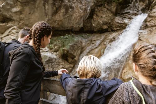 a group of people looking at a waterfall at Apartments Gabl in Schönwies
