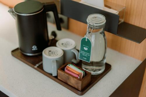 a bottle of water sitting on a wooden shelf at Jiro Hotel in Bandung