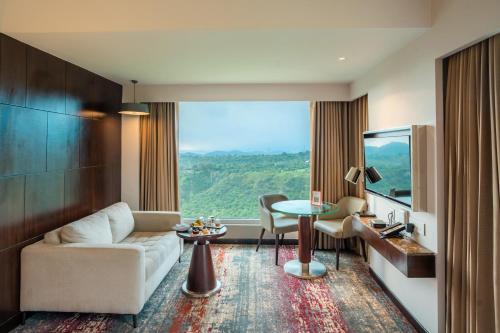a living room with a couch and a table at Welcomhotel By ITC Hotels, Katra in Katra