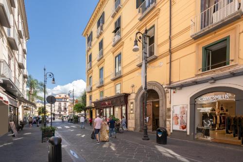 a group of people walking down a street with buildings at The Roof Sorrento in Sorrento