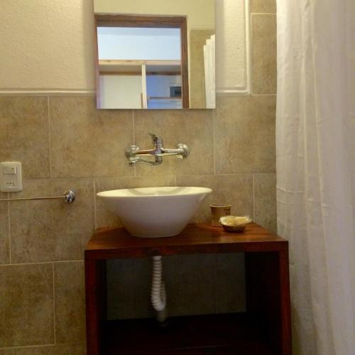 a bathroom with a sink and a mirror at Posada Cova Del Sol in La Pedrera