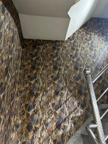 a bathroom with a mosaic tile floor and a pipe at Hotel City Gold in Ajmer