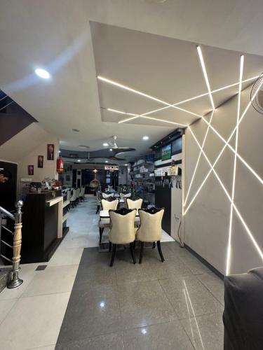 a restaurant with tables and chairs in a room at Hotel City Gold in Ajmer