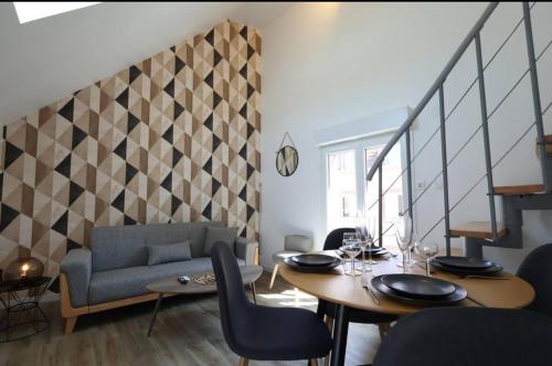 a living room with a table and a couch at Le Chardonnay in Chouilly
