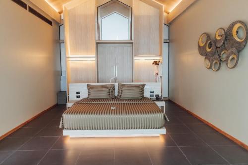 two beds in a room with a window at The Senses Resort & Pool Villas, PHUKET in Patong Beach