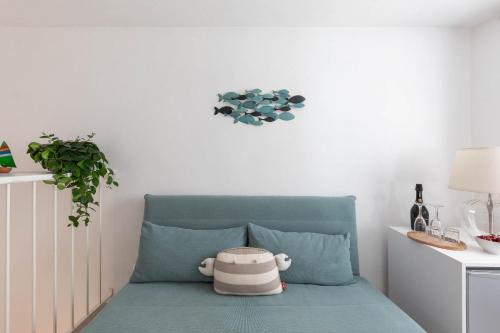 a room with a blue chair with a pot on it at A Casa di Elena in Polignano a Mare