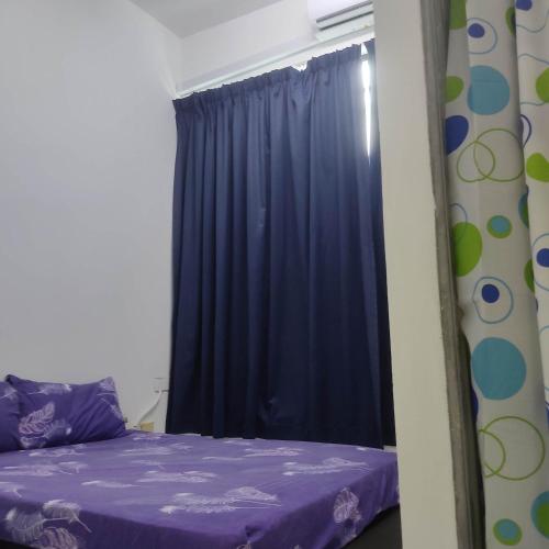 a bedroom with a purple bed and a window at WeJDAN INN BALIK PULAU, PENANG ISLAND in Balik Pulau