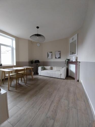 a living room with a table and a couch at Au Coeur de LilleMoulins in Lille