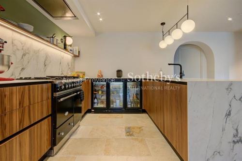 a large kitchen with a stove and a counter at Domaine entier au havre de paix 4 chambres in Vauvenargues